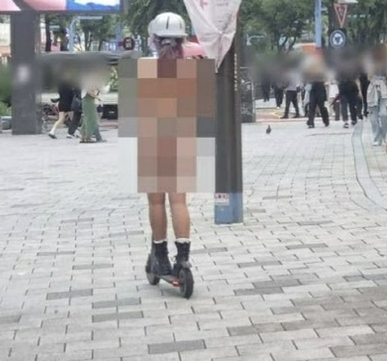 <W解说>韩国一女子穿比基尼骑摩托车备受争议 = 批评不断上升的同时，也有人指出“过度曝光”标准含糊不清